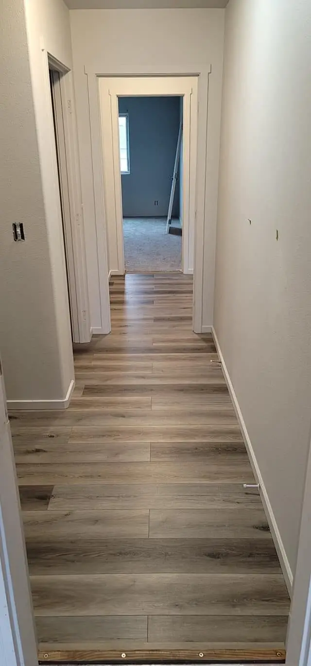 Hallway with plank flooring and fresh paint