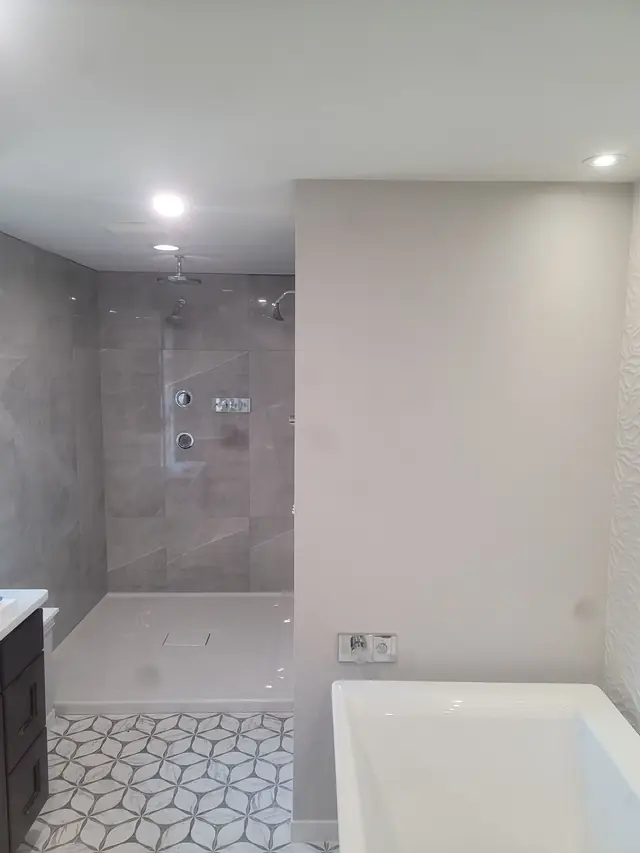 Primary bathroom with a walk-in shower, a freestanding tub and cube-pattern floor tile