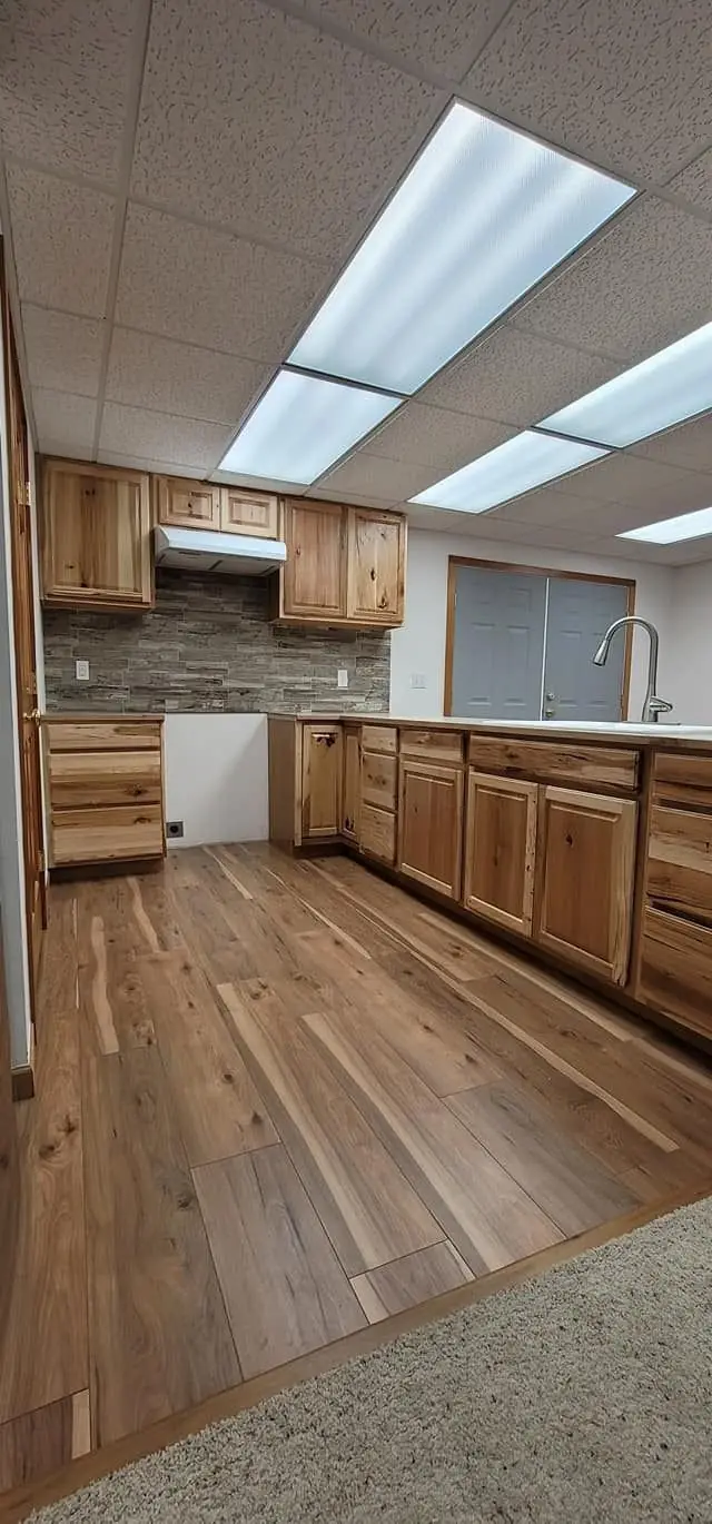Hickory cabinets above plank flooring