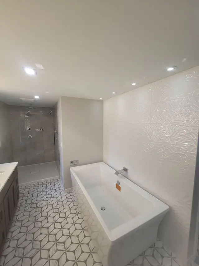 Primary bathroom wide view with a tub and a walk-in shower