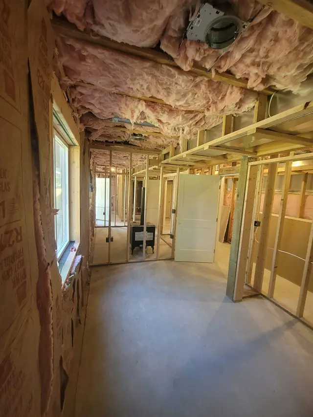 Framed basement walls with insulation in the joists overhead