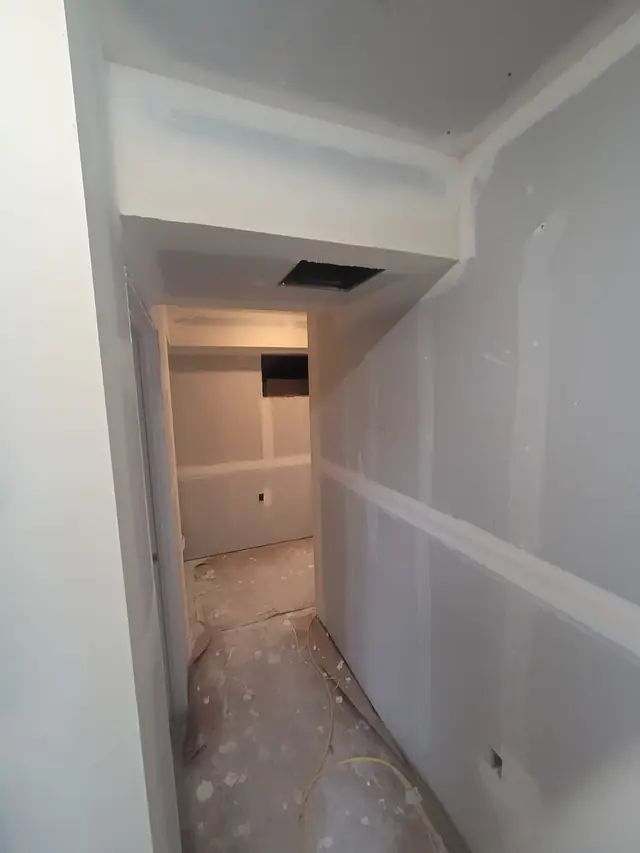 Basement hallway turn with drywall taped