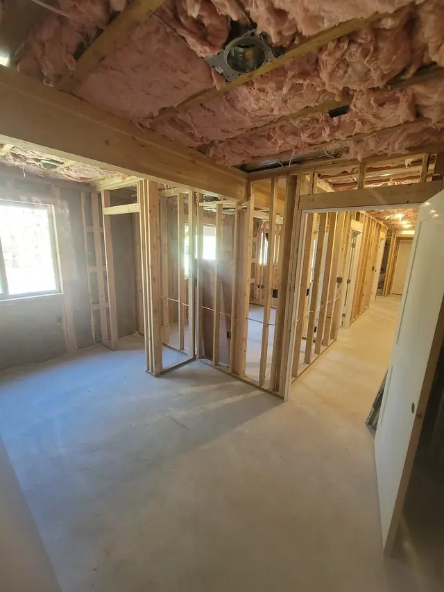 Wide view of a framed basement before drywall